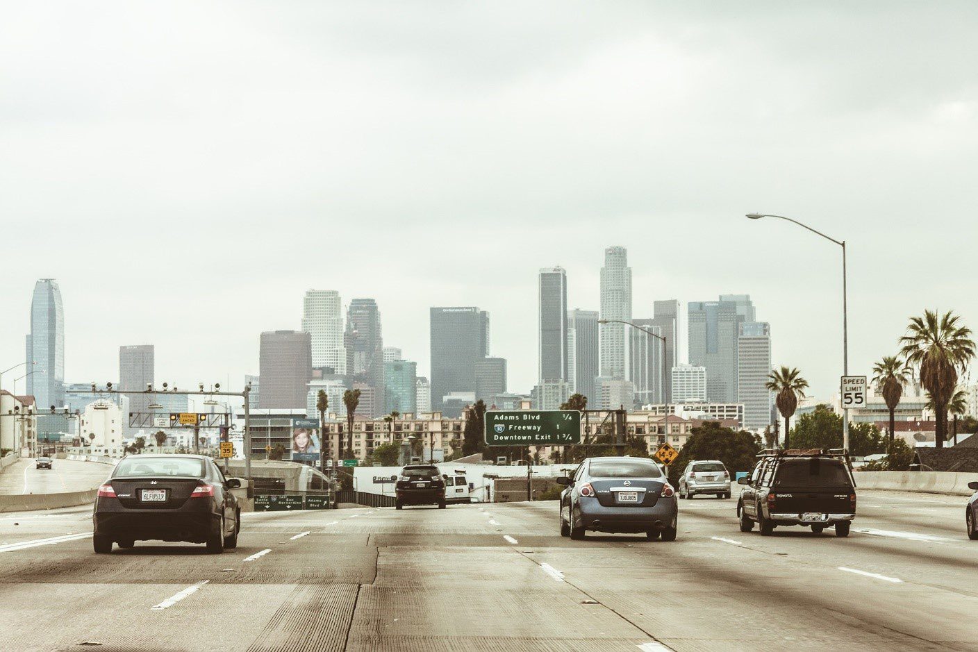 A wide road with a view of skyscrapers