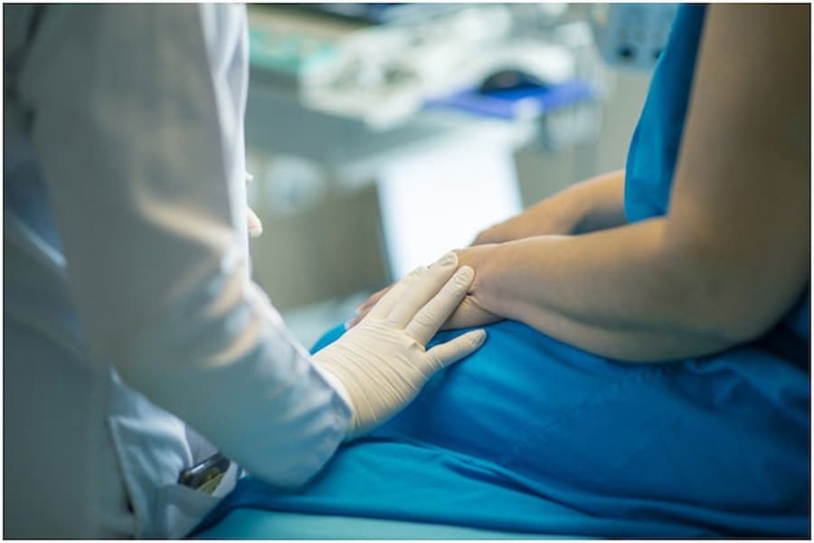 Patient being consoled by doctor