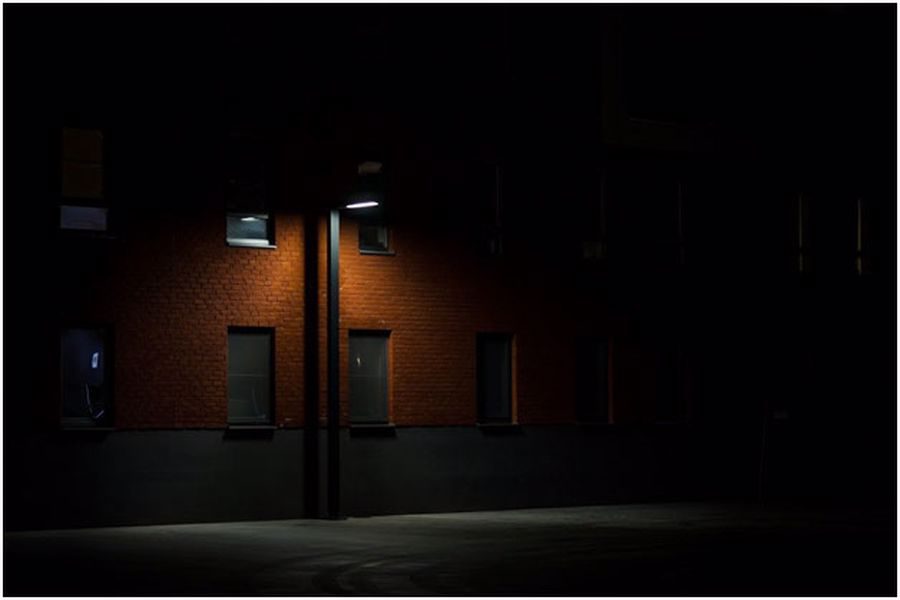 Exterior of an apartment with only one working street lamp