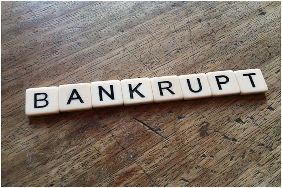 BANKRUPT spelled out with Scrabble game pieces