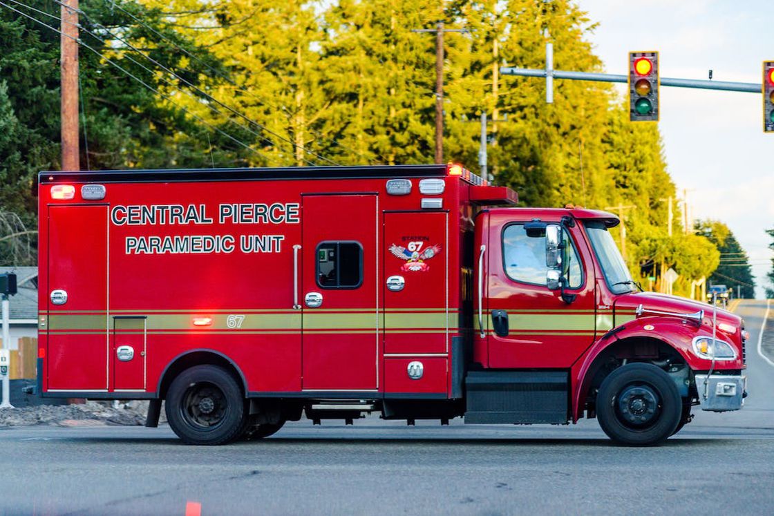 Red paramedic truck being driven in a street