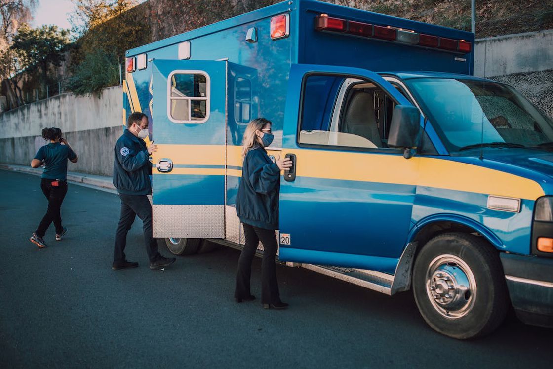 Paramedics entering their blue ambulance