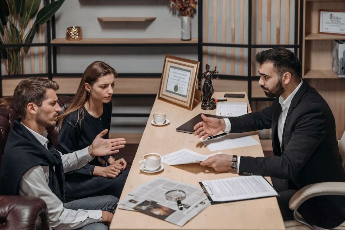 Couple talking with a lawyer