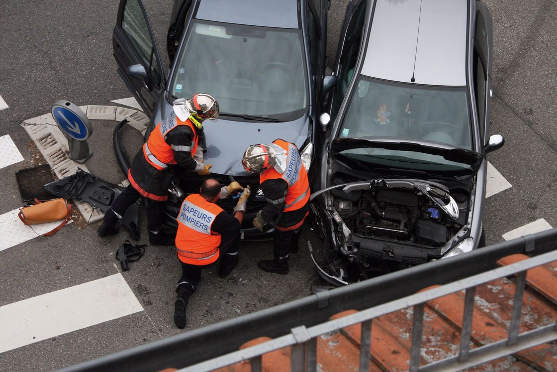 Firefighters inspecting the collision of 2 cars