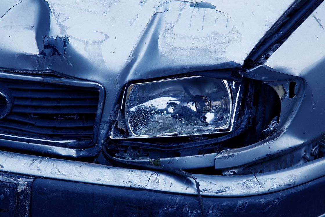 Close up of a car's front end destroyed by an accident