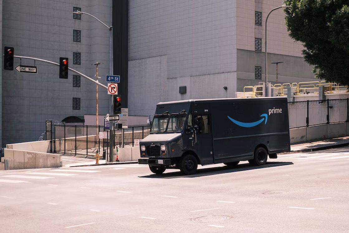 Amazon truck stopped by a stoplight on an empty street