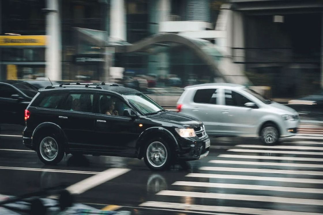 Cars driving on a wet pavement