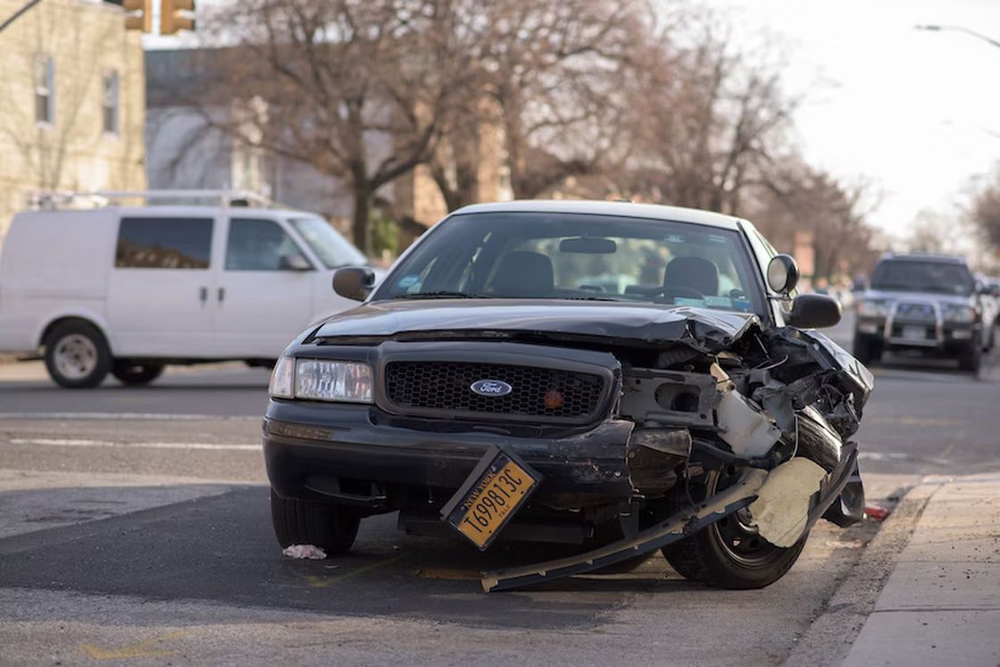 Car with a wrecked front end parked to the side streets after a serious car accident