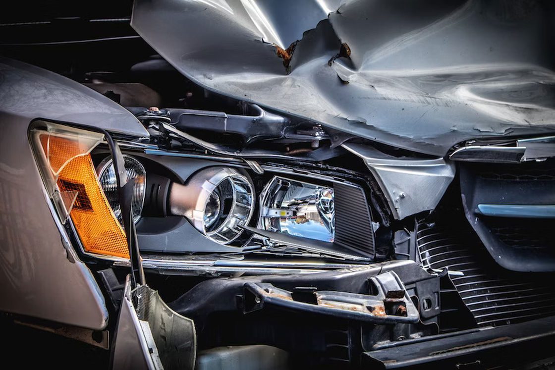 Badly damaged front end of a wrecked car