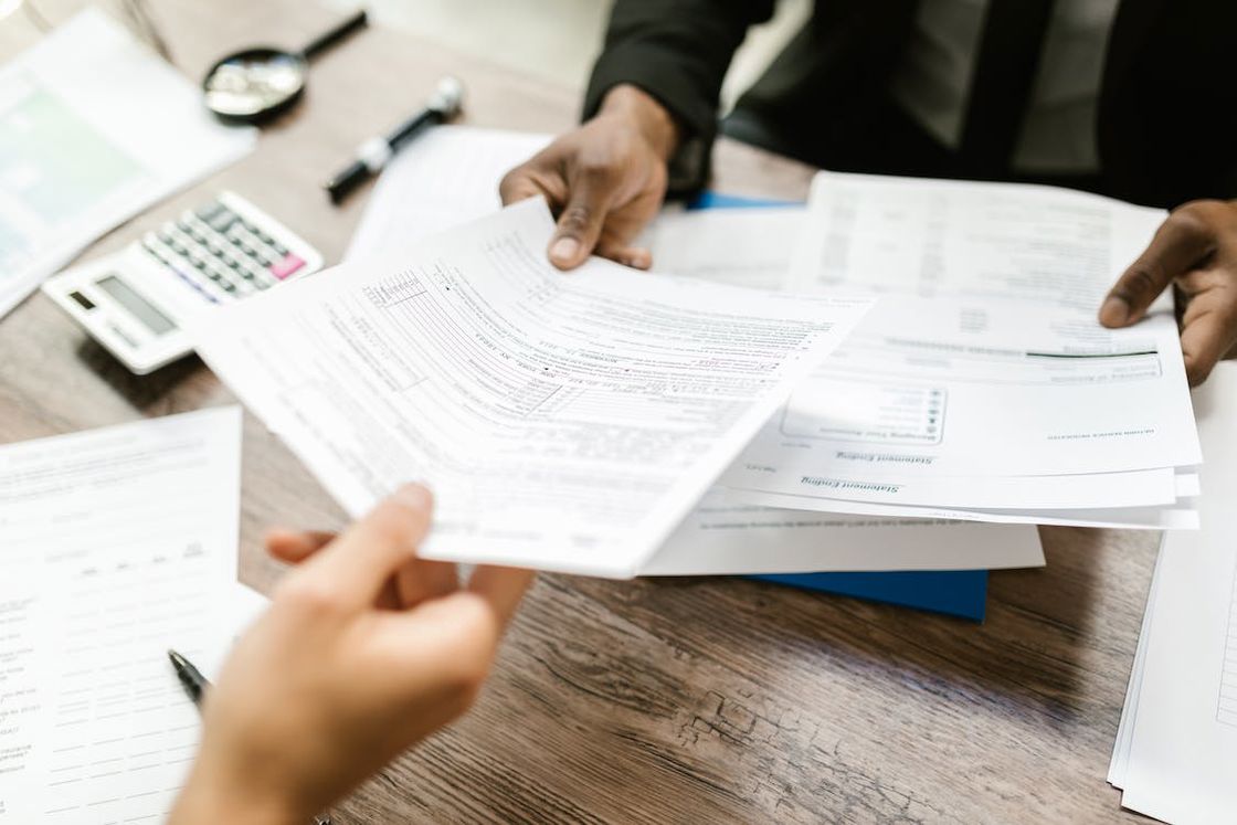 Person handing out documents to a client