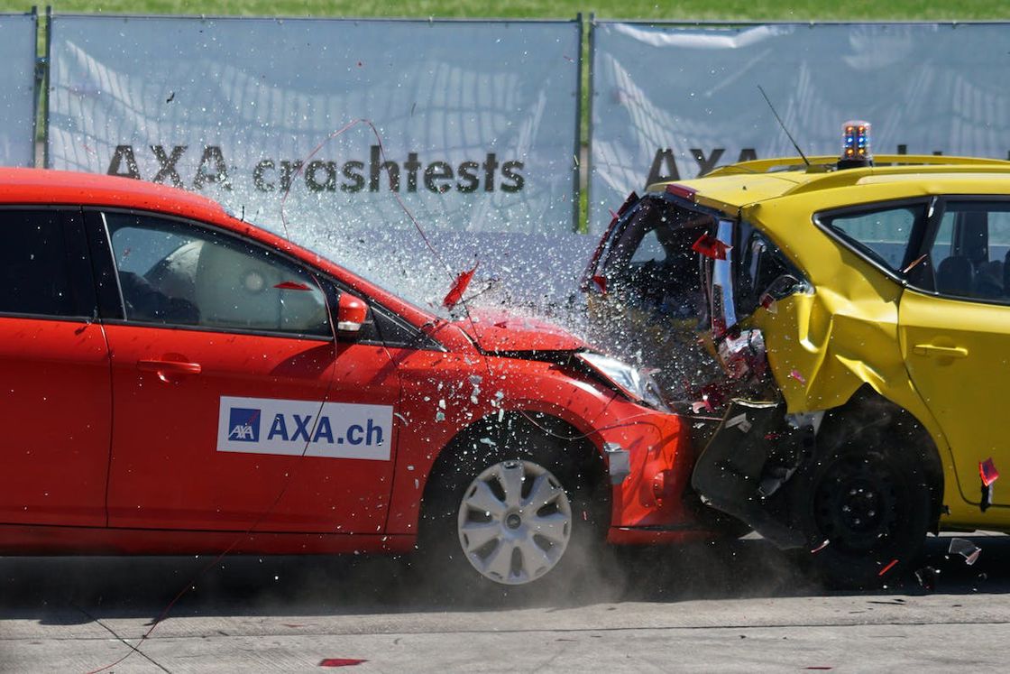 Red car crashing directly to a yellow car