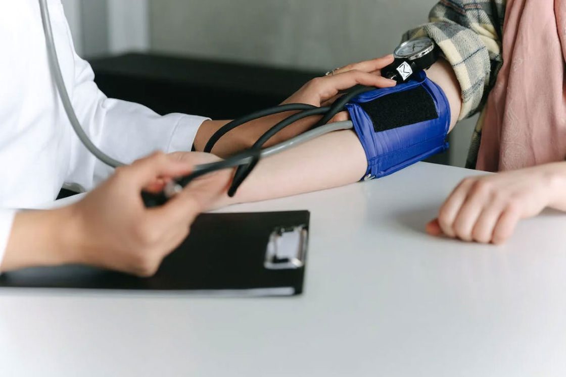 Doctor checking the blood pressure of a patient