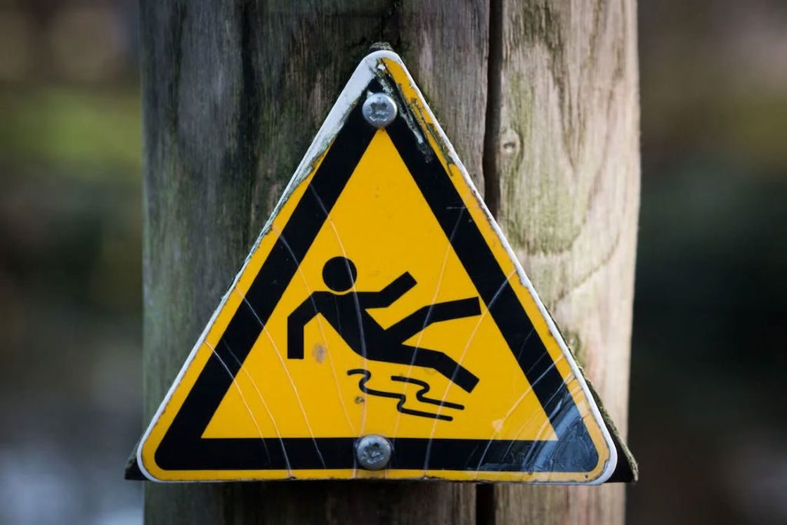 Yellow slippery road signage installed in an electric post