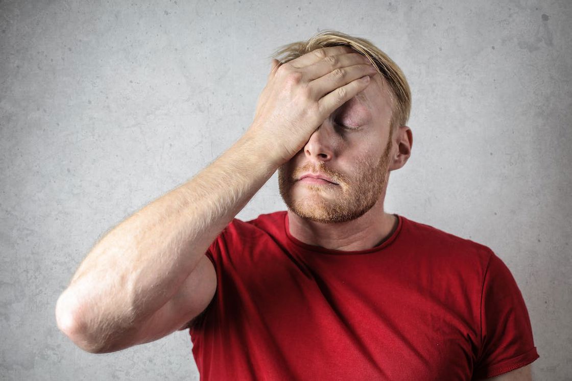 Man with his hand on his forehead