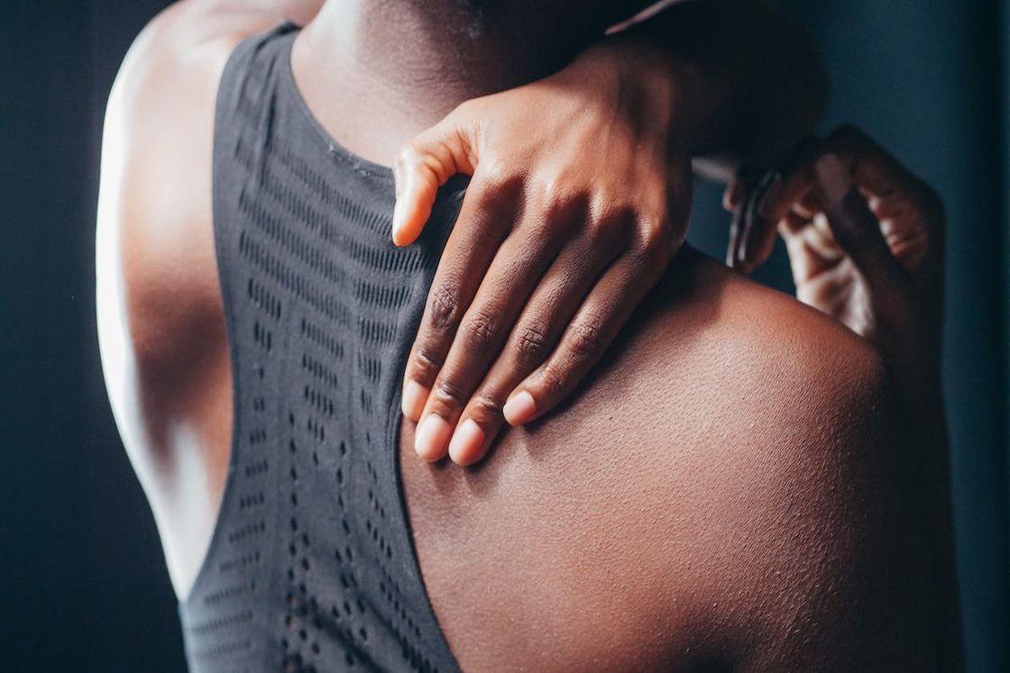 Woman massaging her back from pain