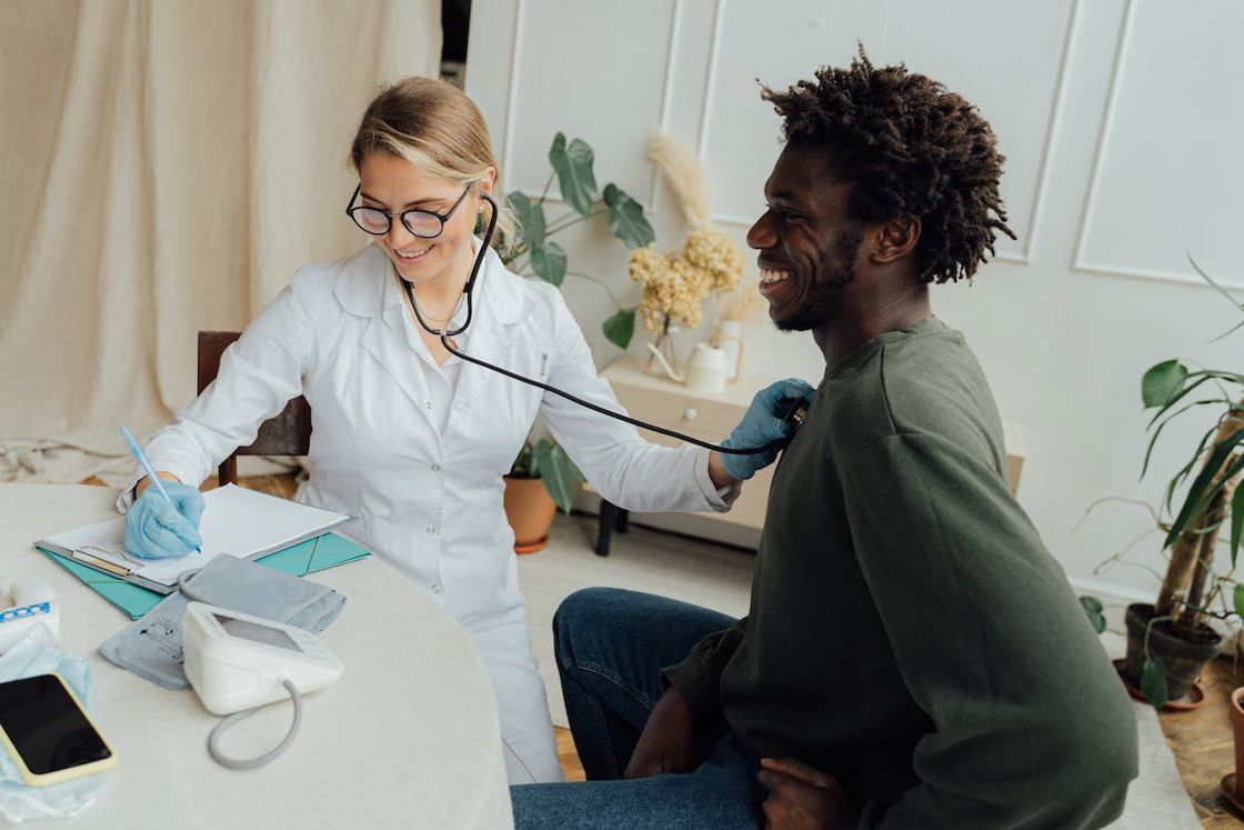 Doctor using a stethoscope to her patient during a checkup