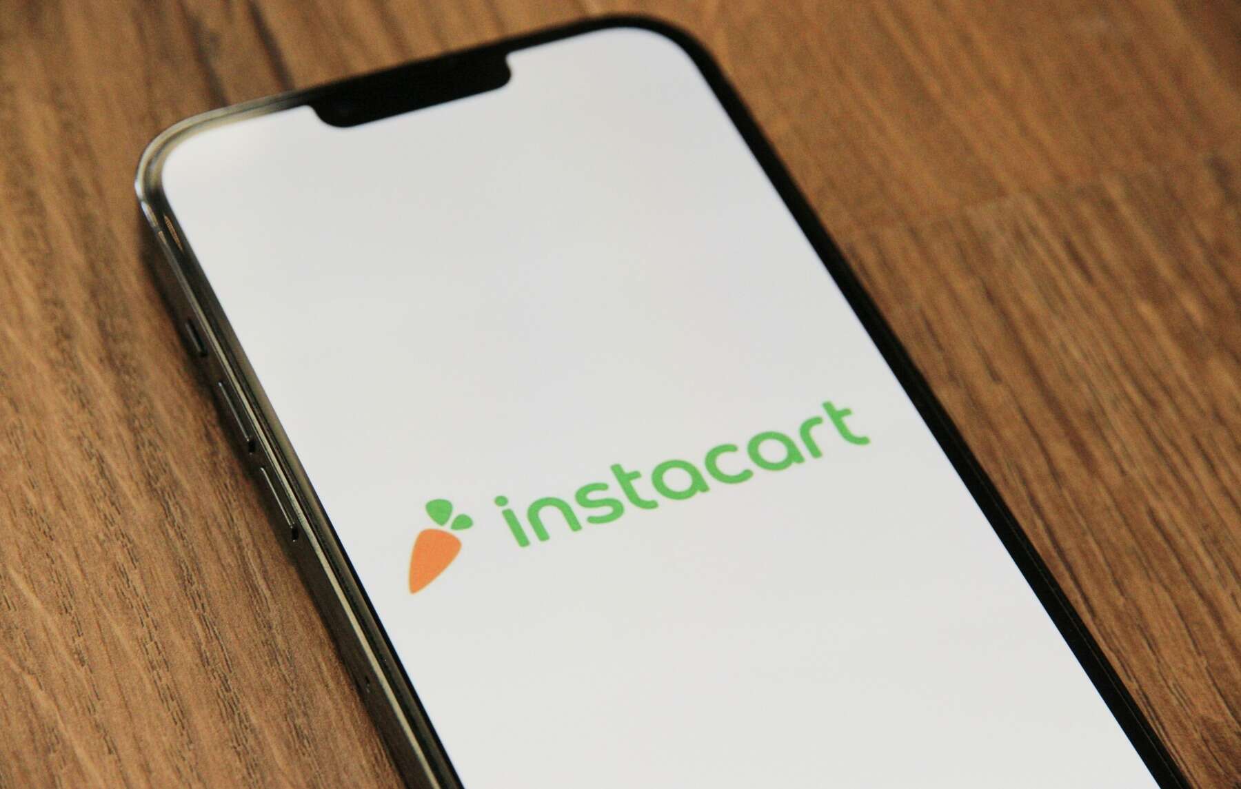 Mobile phone displaying the Instacart app logo