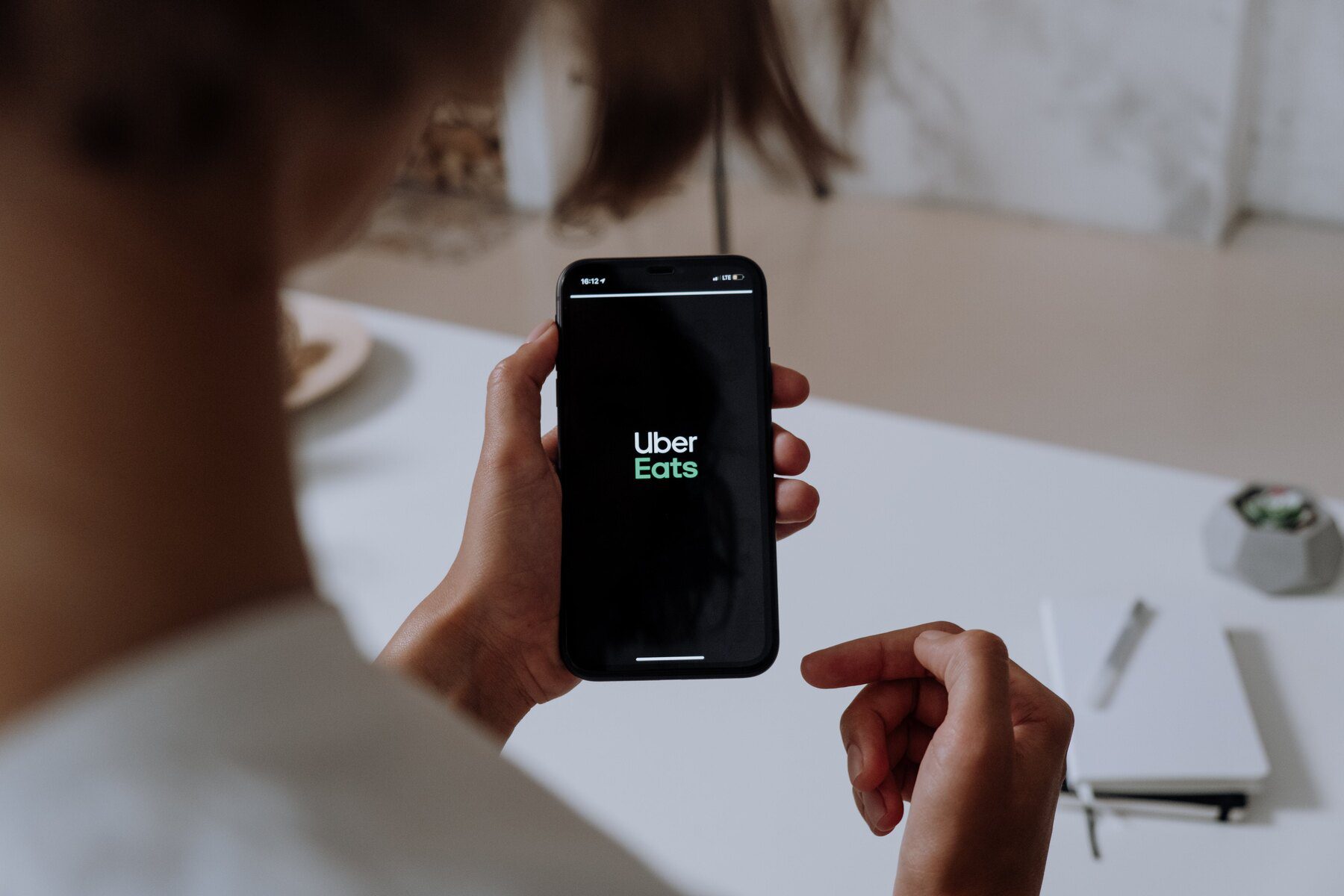 Woman looking at an Uber Eats app on her phone