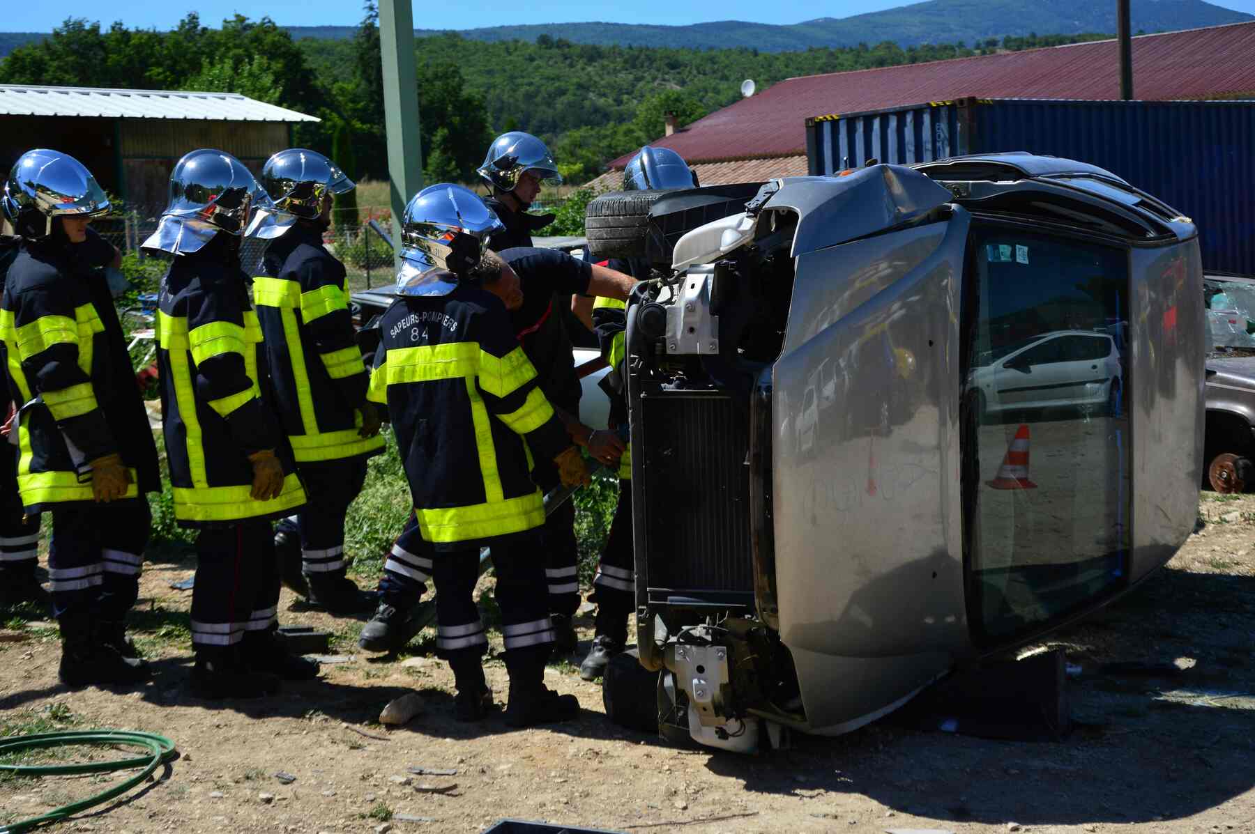 Firefighters checking an overturned car