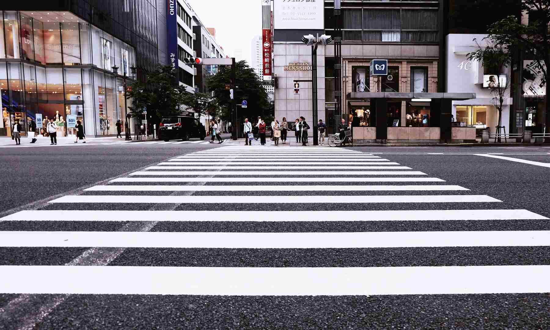 People about to cross the other side of the road