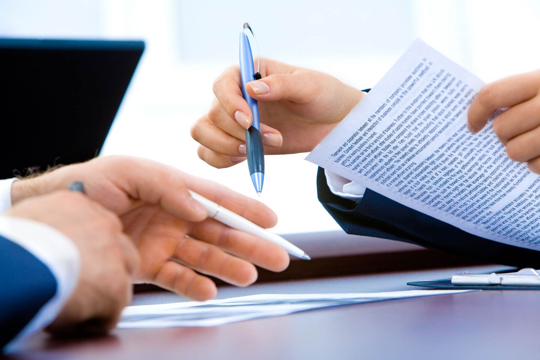 Lawyer assisting where her client should sign on a document