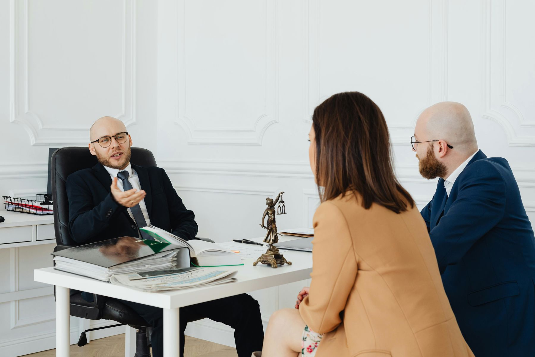 Couple listening to a lawyer during a client meeting