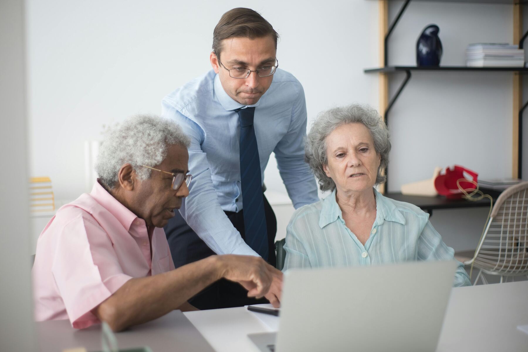 Man trying to assist his elderly couple client