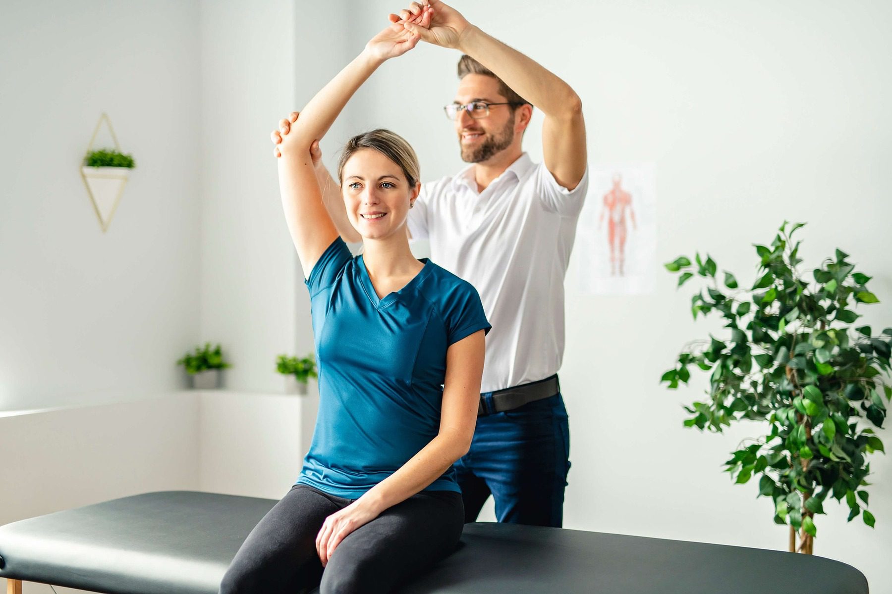 Chiropractor adjusting a woman's arms