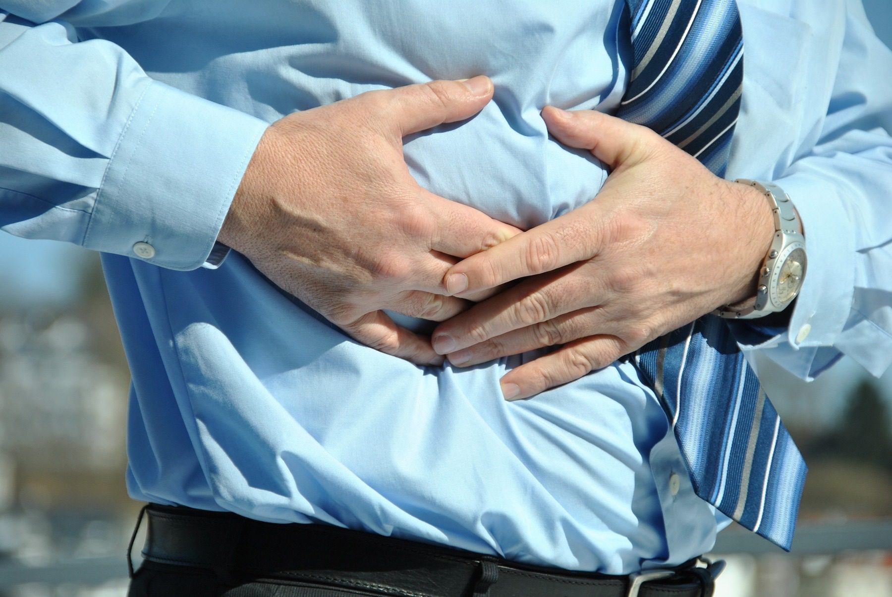 Man holding his stomach in pain