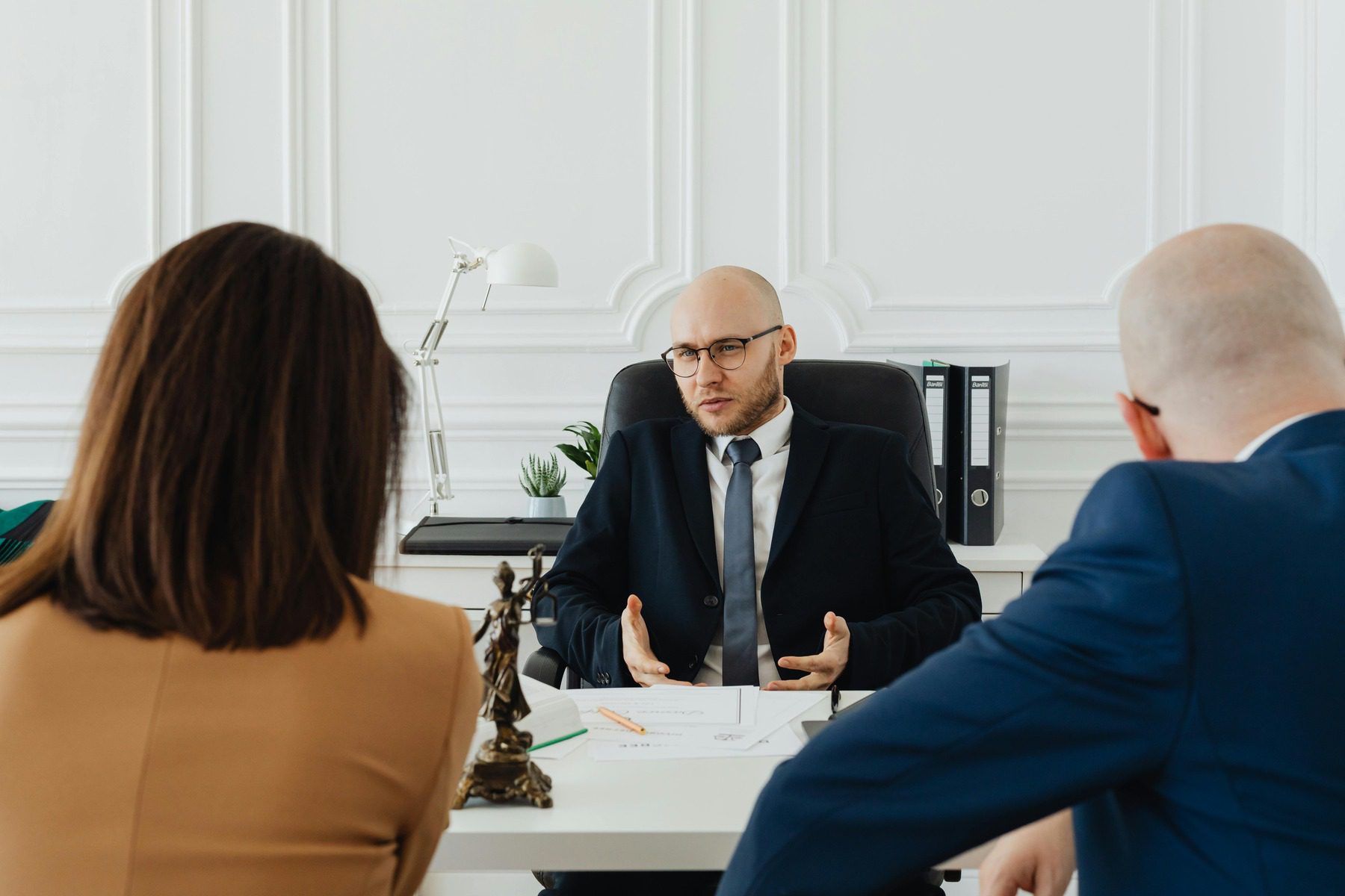 Couple listening while their male lawyer discusses their case