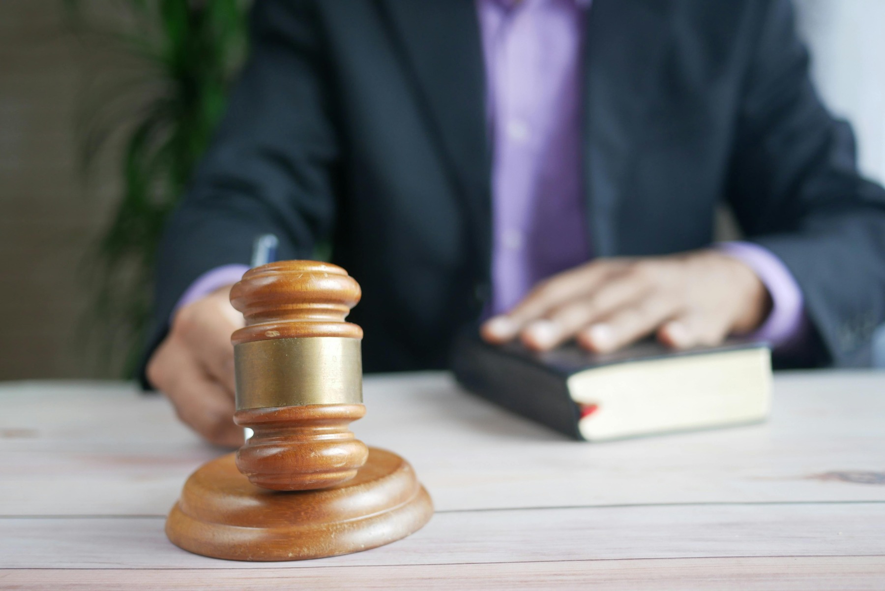 A gavel with an attorney behind