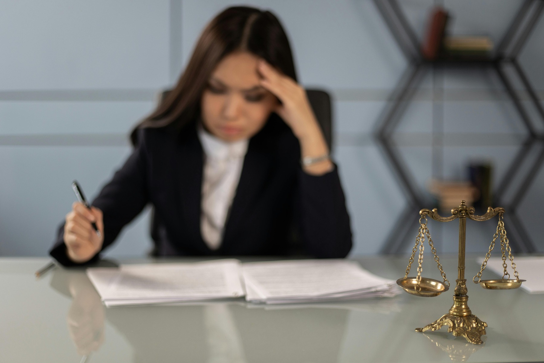 A lawyer looking tired while writing on a document