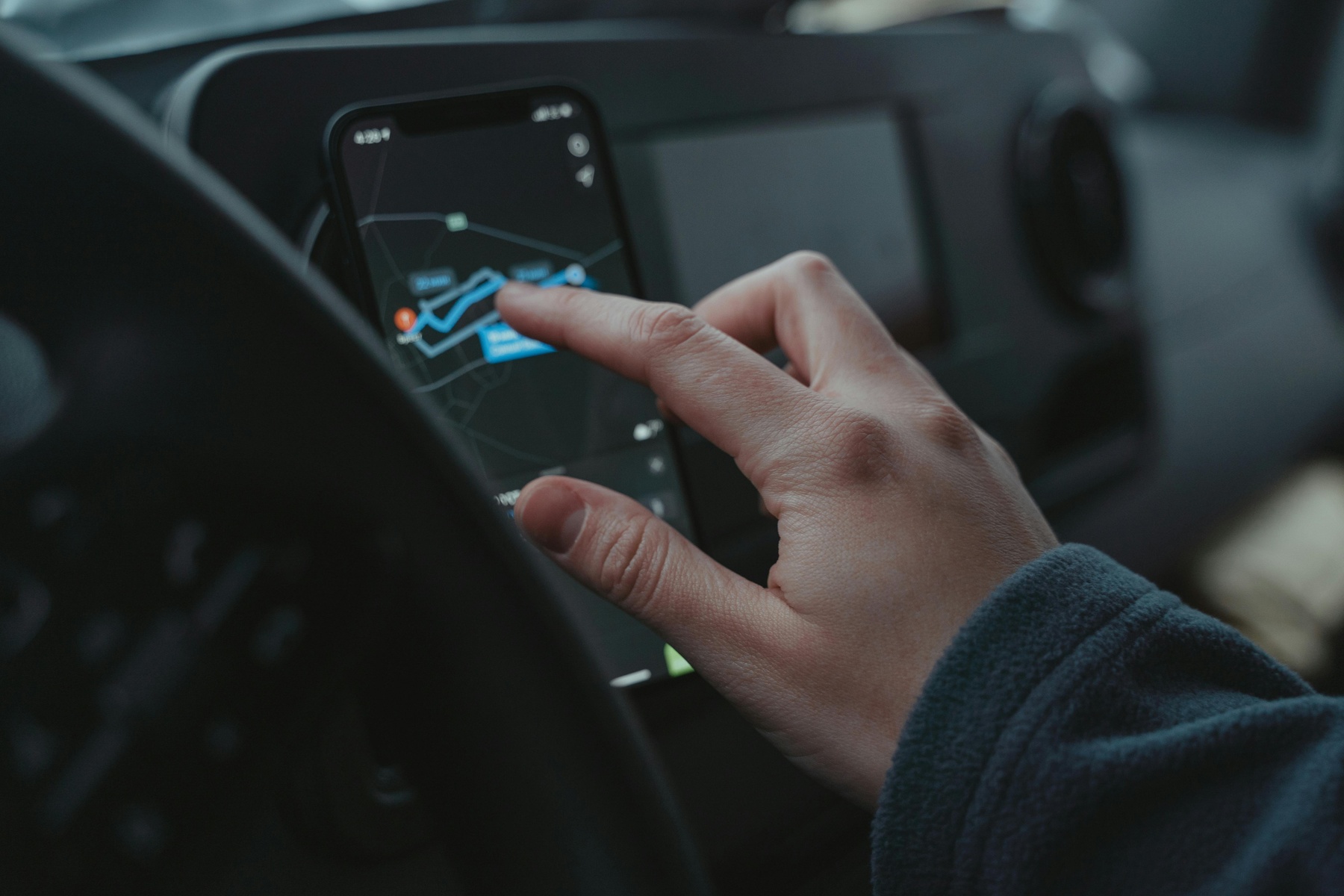 Person using a navigation app while driving