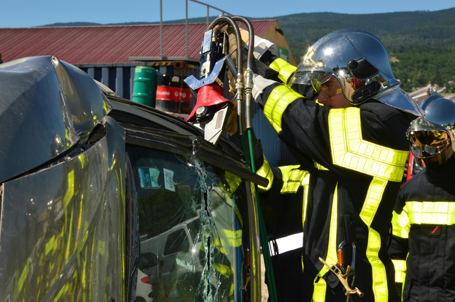 Firefighters trying to cut a wrecked car